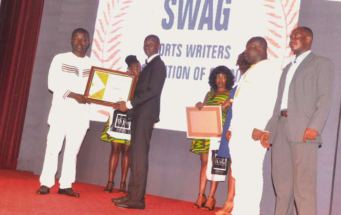 Kuyon (in black suit) receives his SWAG award.